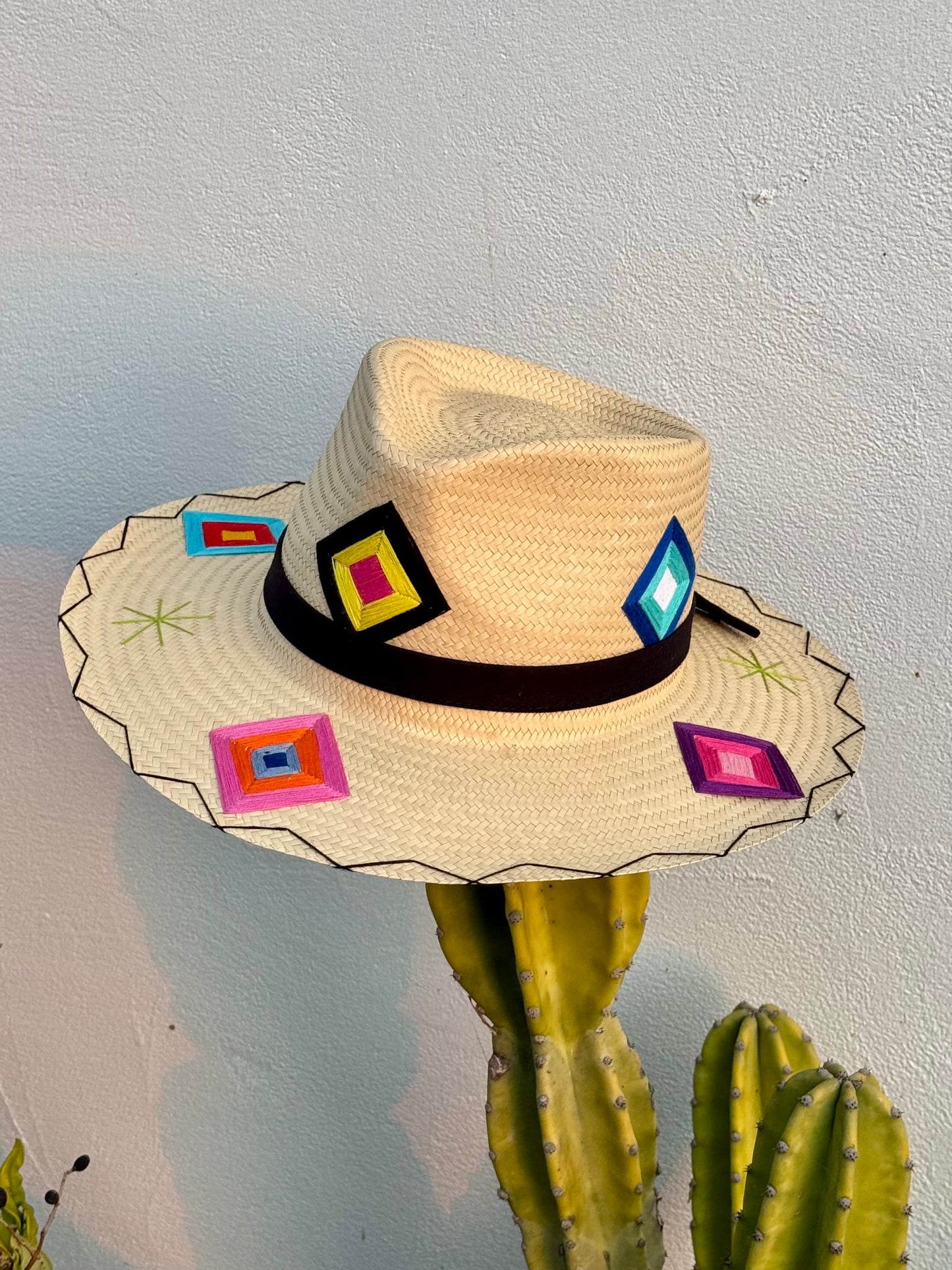 San Jose Sunhat with colorful patches and a black ribbon.